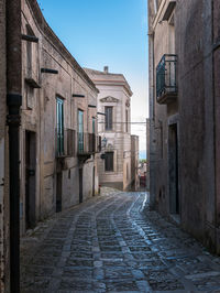 Empty alley amidst buildings in city