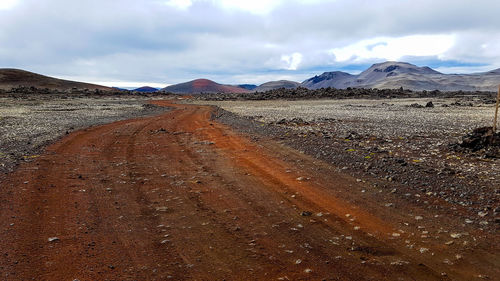 Scenic view of mountains against cloudy sky