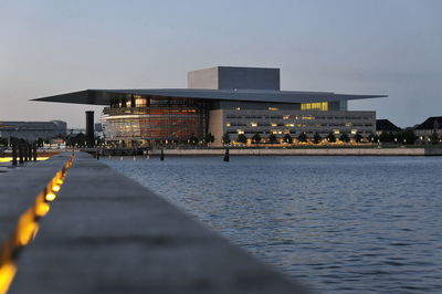 View of illuminated buildings in water