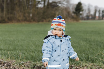 Full length of boy standing on field