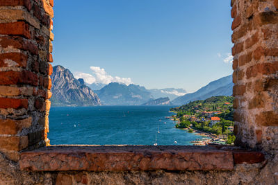 View through window on windsurfers on lake garda near malcesine in italy.