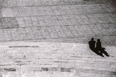 High angle view of people sitting on street