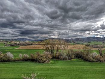 Scenic view of landscape against cloudy sky