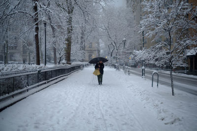 People walking on snow covered landscape