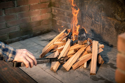 Closeup of pyre of burning wood with flames. production of charcoal for grilling meat wood logs burn