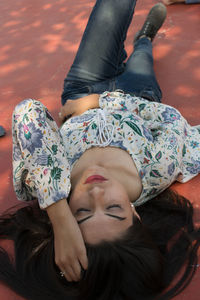 High angle view of woman lying on floor