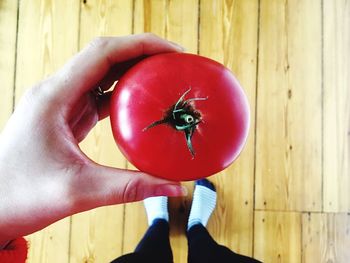 Midsection of person holding strawberry