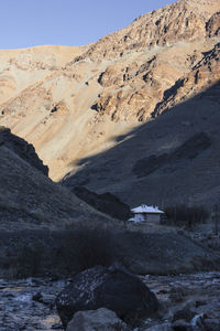 Scenic view of land and mountains against sky