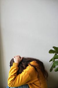 Portrait of woman against wall