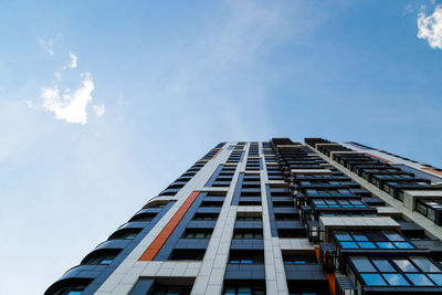 Low angle view of modern building against blue sky