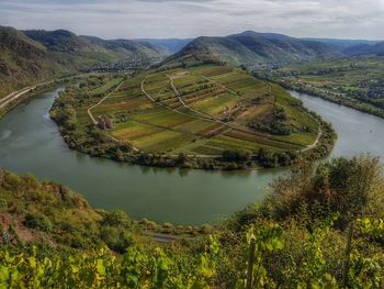 High angle view of lake amidst landscape against sky