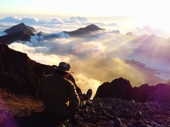 Man looking at mountains against sky