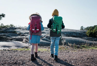 Siblings hiking together by the ocean in finland