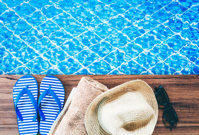 Low section of person wearing hat on swimming pool