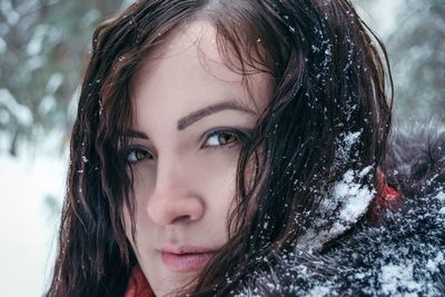 Close-up portrait of woman in snow