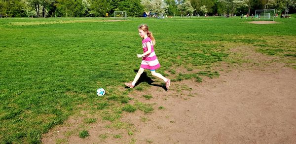 Girl playing with ball on grass