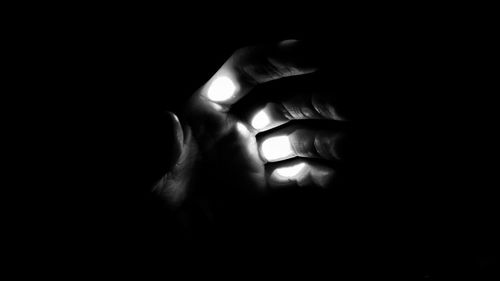 Close-up of human hand in darkroom
