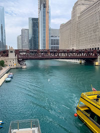 High angle view of bridge over river by buildings against sky