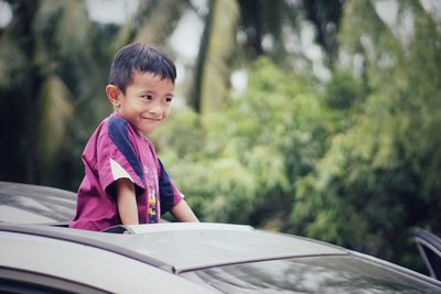 Portrait of cute boy in car