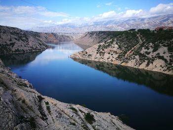 Scenic view of lake amidst mountains against sky