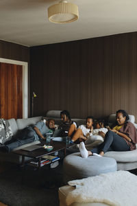 Family relaxing on sofa in living room at home