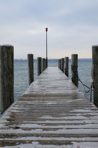 Pier over sea against sky