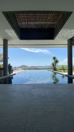 View of swimming pool by building against sky