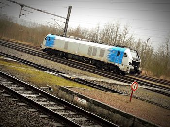 Train on railroad tracks against sky