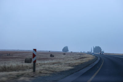 Road by landscape against clear sky