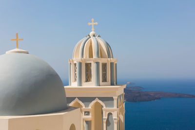 Close-up of church by aegean sea against sky