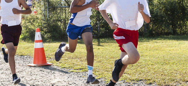 Low section of men running at park