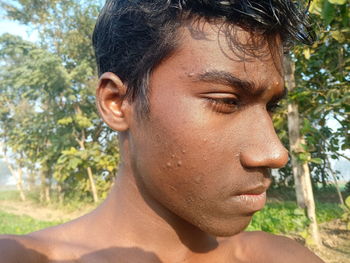 Close-up portrait of young man looking away