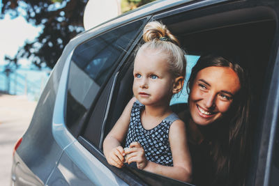 Portrait of a smiling girl in car