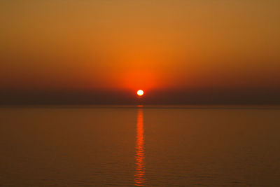 Scenic view of sea against romantic sky at sunset