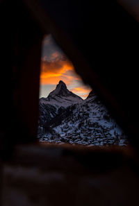 Scenic view of snowcapped mountains against sky during sunset