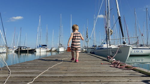 Rear view of child on pier