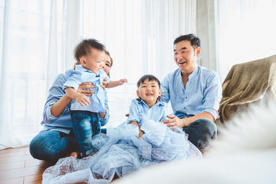 Happy friends sitting on floor