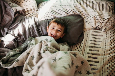 Portrait of cute baby lying on bed