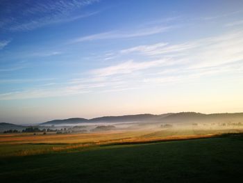 Scenic view of field against sky during sunset