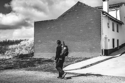 Man photographing against sky