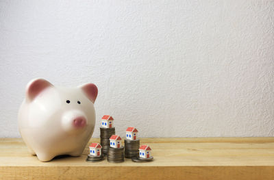 Close-up of toys on table against white wall