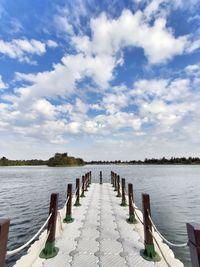 Scenic view of pier over lake against sky