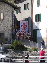 People on street amidst buildings in city