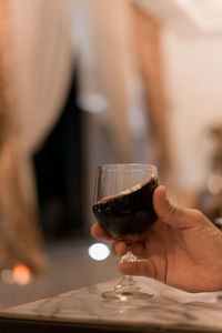 Midsection of man drinking wine in glass