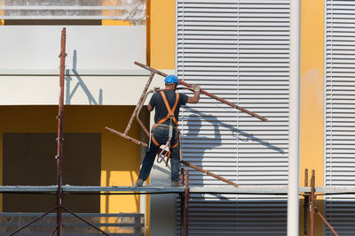 Low angle view of man working at construction site