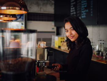 Barista making coffee at cafe