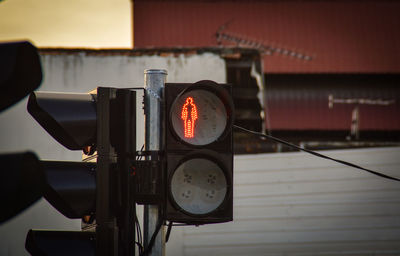 Close-up of pedestrian crossing sign in city