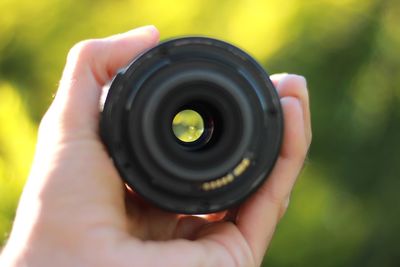 Cropped hand holding camera