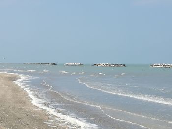 Scenic view of beach against clear sky