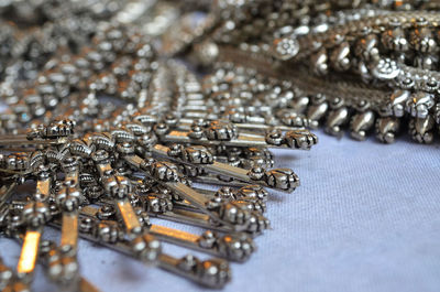 High angle view of antique jewelry for sale at market stall